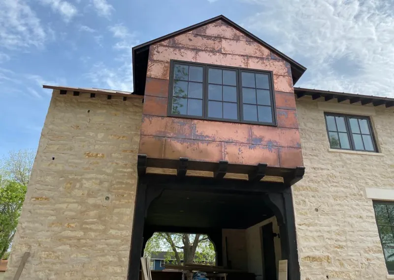 Copper metal panel facade on a stone building for Skylight Installation in Agawam Town